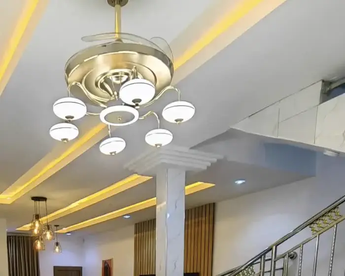 Gold chandelier and marble staircase